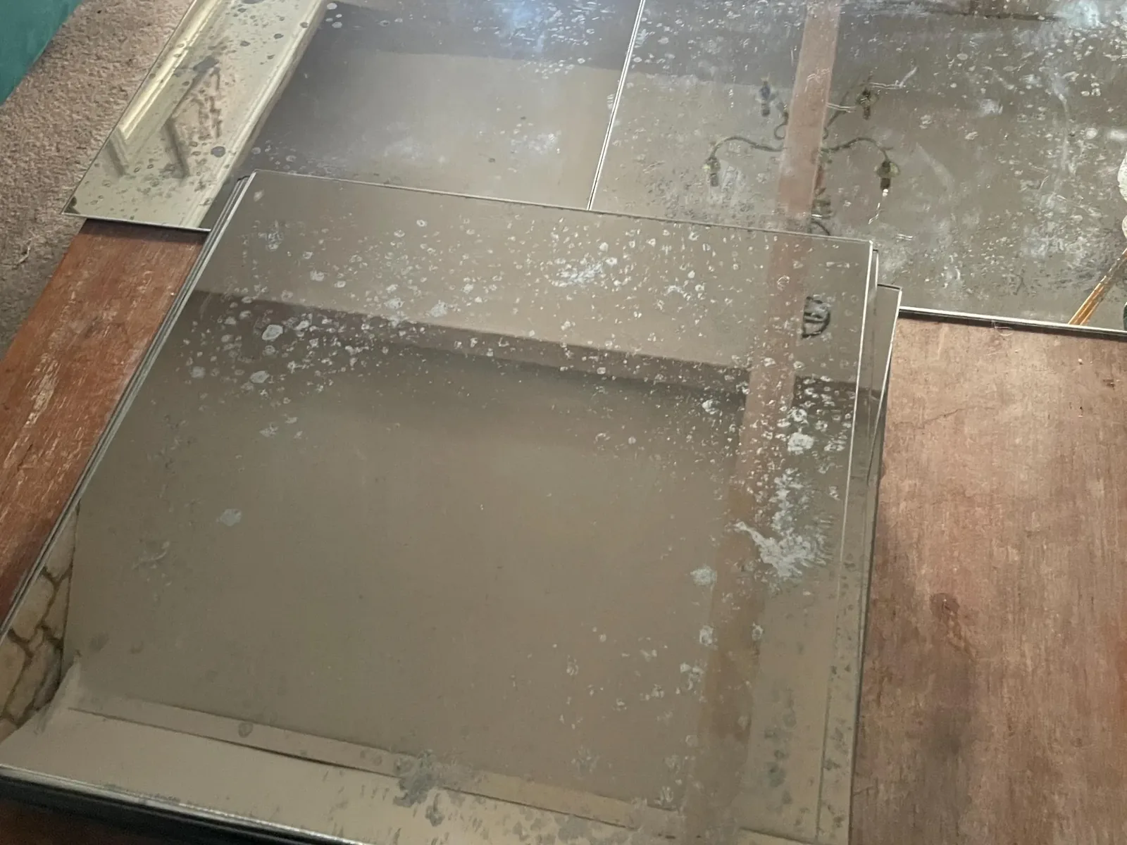 Distressed mirror tiles in progress on the workshop bench